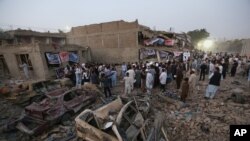 Afghan civil society members light candles during a vigil for victims of Friday's attacks, while gathering at the site of a truck bomb attack in Kabul, Afghanistan, Aug. 8, 2015. 