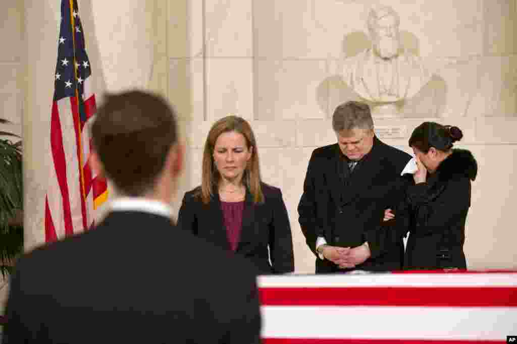 A woman cries as friends and staff of the Supreme Court attend a private ceremony in the Great Hall of the Supreme Court where late Supreme Court Justice Antonin Scalia lies in repose, Feb. 19, 2016, in Washington. 