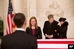 A woman cries as friends and staff of the Supreme Court attend a private ceremony in the Great Hall of the Supreme Court where late Supreme Court Justice Antonin Scalia lies in repose, Feb. 19, 2016, in Washington.