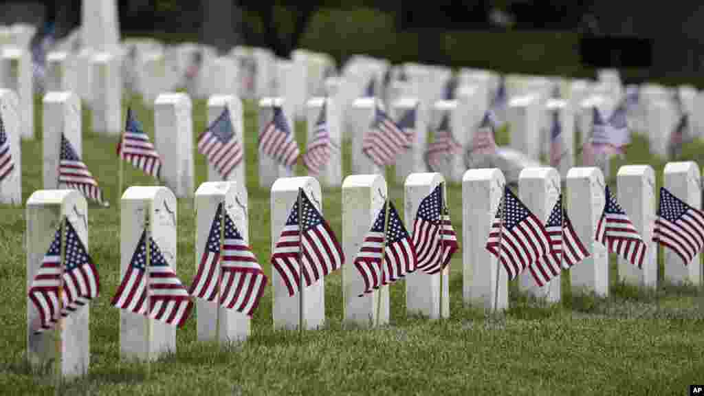 American flags are displayed next to veterans' graves ahead of Memorial Day at the Crown Hill National Cemetery in Indianapolis, Indiana, May 29, 2021.