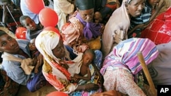 Women wait for medical care at Camp Seyidka, a camp for displaced people, in Mogadishu, Somalia, Aug. 19, 2011