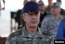 FILE - Turkey's Hulusi Akar, when he was chief of the general staff, during a military exercise near the Aegean port city of Izmir, Turkey, May 10, 2018.