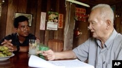 Thet Sambath, filmmaker of the 'Enemies of the People', talking to former Khmer Rouge leader Nuon Chea. 