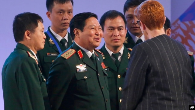 FILE - Vietnamese Defense Minister Gen. Ngo Xuan Lich, center, talks to then-Australian Defense Minister Marise Payne at the two-day ASEAN Defense Ministers Meeting, Oct. 24, 2017, north of Manila, Philippines.