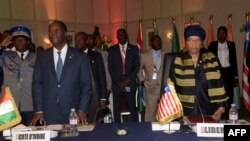 Ivory Coast's president Alassane Ouattara (L) and Liberia's president Ellen Johnson Sirleaf look on during the 49th summit of the Economic Community of West African States (ECOWAS) in Dakar, Senegal, June 4, 2016. 