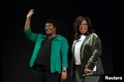 FILE - Oprah Winfrey takes part in a town hall meeting with Democratic gubernatorial candidate Stacey Abrams ahead of the midterm election in Marietta, Georgia, Nov. 1, 2018.