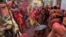 Veiled Hindu women playfully beat men with bamboo sticks as they take part in "Lathmar Holi" celebrations in the town of Nandgaon, Uttar Pradesh, India, March 9, 2025.