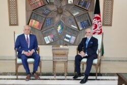 FILE - U.S. envoy for peace in Afghanistan Zalmay Khalilzad meets Abdullah Abdullah, Chairman of the High Council for National Reconciliation in Kabul, Afghanistan, March 1, 2021.