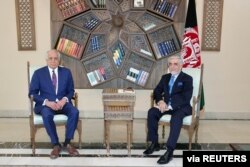 FILE - U.S. envoy for peace in Afghanistan Zalmay Khalilzad meets Abdullah Abdullah, Chairman of the High Council for National Reconciliation in Kabul, Afghanistan, March 1, 2021.