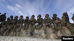 Afghan soldiers wait before the handover ceremony between French army and ANA (Afghan National Army) at the forward operational base of Nijrab as part of the withdrawal of the French troops November 20, 2012. 