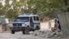 A Somali police ambulance leaves from the scene of an explosion in a restaurant often patronized by police officers, near a police training camp in Mogadishu, Somalia, Oct. 17, 2024.