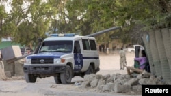 A Somali police ambulance leaves from the scene of an explosion in a restaurant often patronized by police officers, near a police training camp in Mogadishu, Somalia, Oct. 17, 2024.