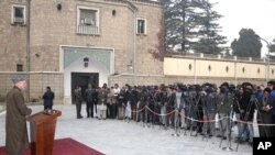 In this handout photograph provided by the Afghan Presidential Palace, President Hamid Karzai gives a press conference on Eid al-Adha in Kabul, 27 Nov 2009