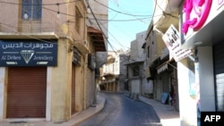 FILE - This picture shows closed shops on an empty street in the eastern Lebanese city of Baalbeck on Oct. 19, 2024. 