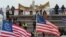 Supporters of U.S. President Donald Trump hold a "We the People" banner, a Three Percenters flag and a 13-star Betsy Ross U.S. flag, gather in front of the U.S. Capitol Building in Washington, Jan. 6, 2021. 