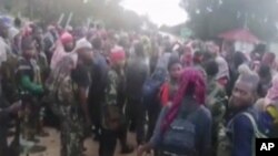 In this image taken from militant video released by the Islamic State group on Monday March 29, 2021, purporting to show fighters near the strategic north eastern Mozambique town of Palma, as the militant group claimed it had taken control of the…
