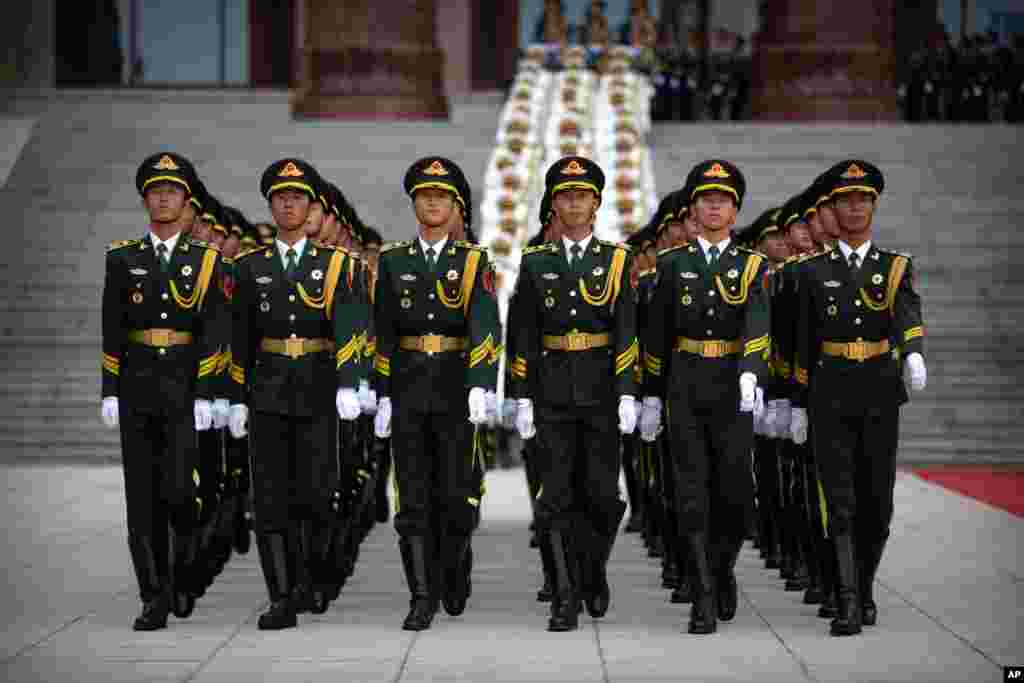 Honor guard members march before a welcome ceremony for Turkish President Recep Tayyip Erdogan at the Great Hall of the People in Beijing, China.