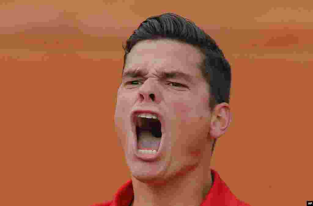 Canada&#39;s Milos Raonic celebrates winning the fourth round match of the French Open tennis tournament against Spain&#39;s Marcel Granollers at the Roland Garros stadium, in Paris, France. Raonic won in three sets 6-3, 6-3, 6-3.