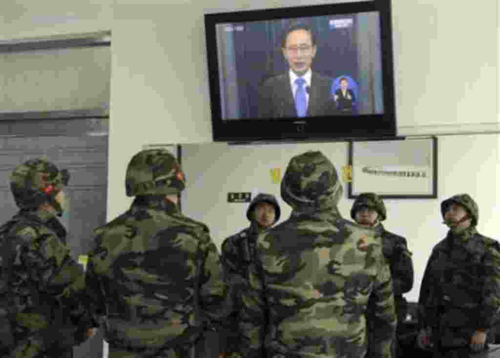 South Korean marines watch a live television broadcast of President Lee Myung-bak's speech, on Yeonpyeong Island, South Korea, Monday, Nov. 29, 2010. Lee took responsibility for failing to protect his citizens from a deadly North Korean artillery attack l