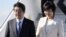 Japanese Prime Minister Shinzo Abe and his wife, Akie, arrive at the Helsinki International Airport in Vantaa, Finland, July 9, 2017, the second leg of Abe's Nordic tour. Abe's approval ranking has fallen at home.