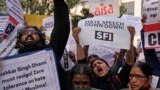 FILE - Activists of various left organizations shout slogans during a protest against hate speech in New Delhi, India, Dec.27 2021.