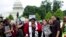 FILE - Rev. Dr. William Barber II, accompanied by Rev. Dr. Liz Theoharis and Rev. Jesse Jackson, speaks to the crowd outside of the U.S. Capitol during a Poor People's Campaign rally at The National Mall in Washington, June 23, 2018.