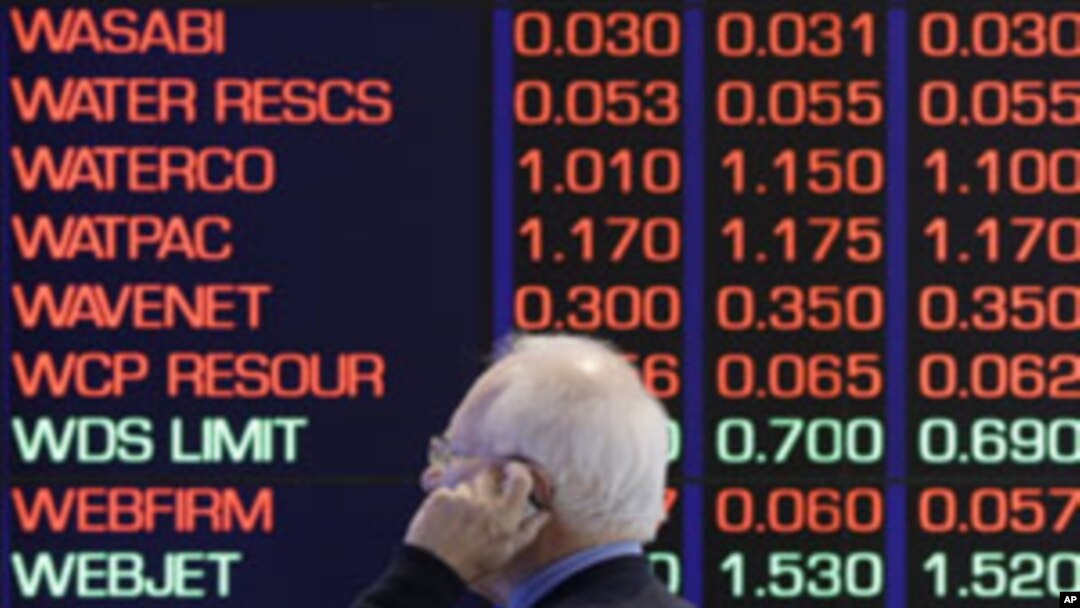 A man talks on his cellular phone at the Australian Stock market in Sydney, August 9, 2011