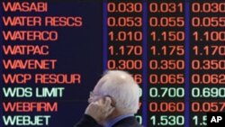 A man talks on his cellular phone at the Australian Stock market in Sydney, August 9, 2011