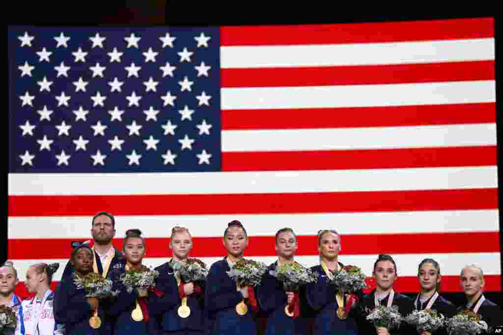 Team USA listens to the national anthem after winning the gold medal in the women&#39;s team final at the Gymnastics World Championships in Stuttgart, Germany.