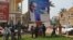 People stand under the poster of Central Africa Republic's President Francois Bozize in Bangui on December 28, 2012