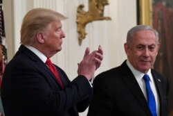 President Donald Trump, left, listens as Israeli Prime Minister Benjamin Netanyahu, right, speaks during an event in the East Room of the White House in Washington, Jan. 28, 2020.