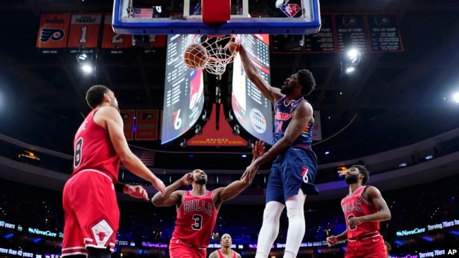 Philadelphia 76ers' Joel Embiid (21) dunks the ball against Chicago Bulls' Tristan Thompson (3) during the second half of an NBA basketball game, Monday, March 7, 2022, in Philadelphia. (AP Photo/Matt Slocum)