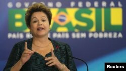 Brazil's President Dilma Rousseff gestures during an announcement of the construction of the first 50 port terminals for private use (TUP), at the Planalto Palace in Brasilia, July 3, 2013. 