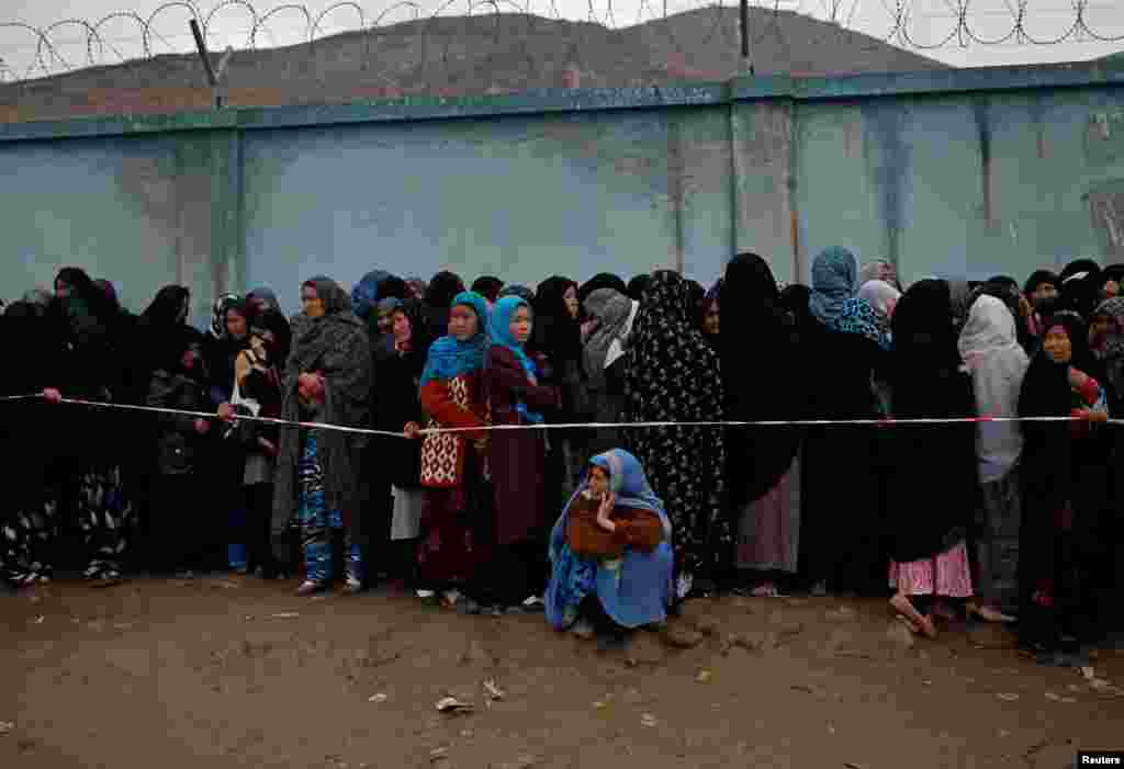 Women stand in line to vote at a polling station in Kabul.