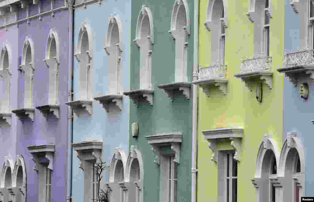 Painted property fronts are seen in a residential street in London, Britain.