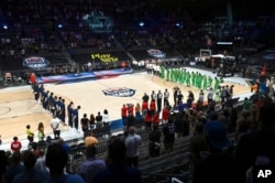 FILE - United States and Nigeria stand for the national anthem before their exhibition basketball game in Las Vegas, July 10, 2021.