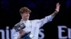 Jannik Sinner of Italy waves as he carries the Norman Brookes Challenge Cup after defeating Alexander Zverev of Germany in the men's singles final at the Australian Open tennis championship in Melbourne, Jan. 26, 2025.