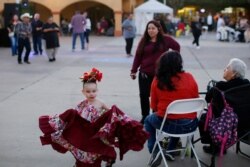 FILE - In this Feb. 8, 2020 photo, people gather during the celebration of the town's 45th year since it was incorporated, in Guadalupe, Ariz.