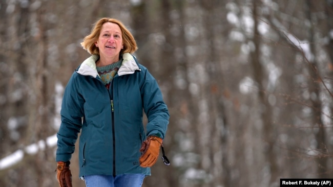 Judy Sandler was diagnosed with ADHD in her 50s. In this photo, she walks in the woods near her home in Lincolnville, Maine, January 23, 2025. (AP Photo/Robert F. Bukaty)