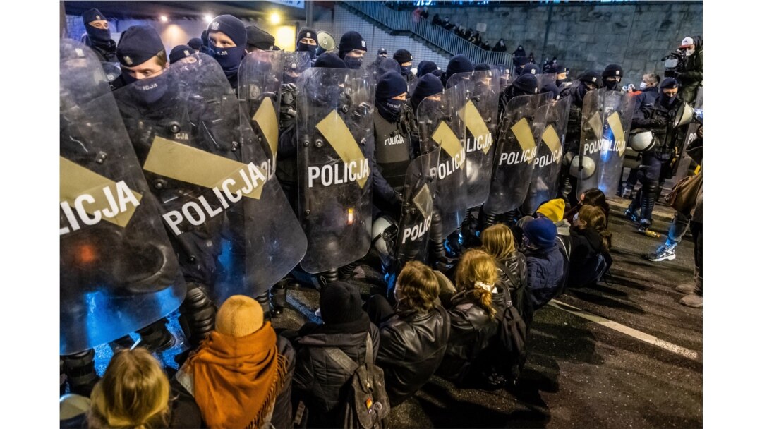 FILE - Police secure the road as demonstrators try to block traffic during a pro-choice protest in the center of Warsaw, Nov. 28, 2020.