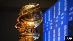FILE - Golden Globe trophies are set by the stage ahead of the 77th Annual Golden Globe Awards nominations announcement at the Beverly Hilton hotel in Beverly Hills on Dec. 9, 2019.