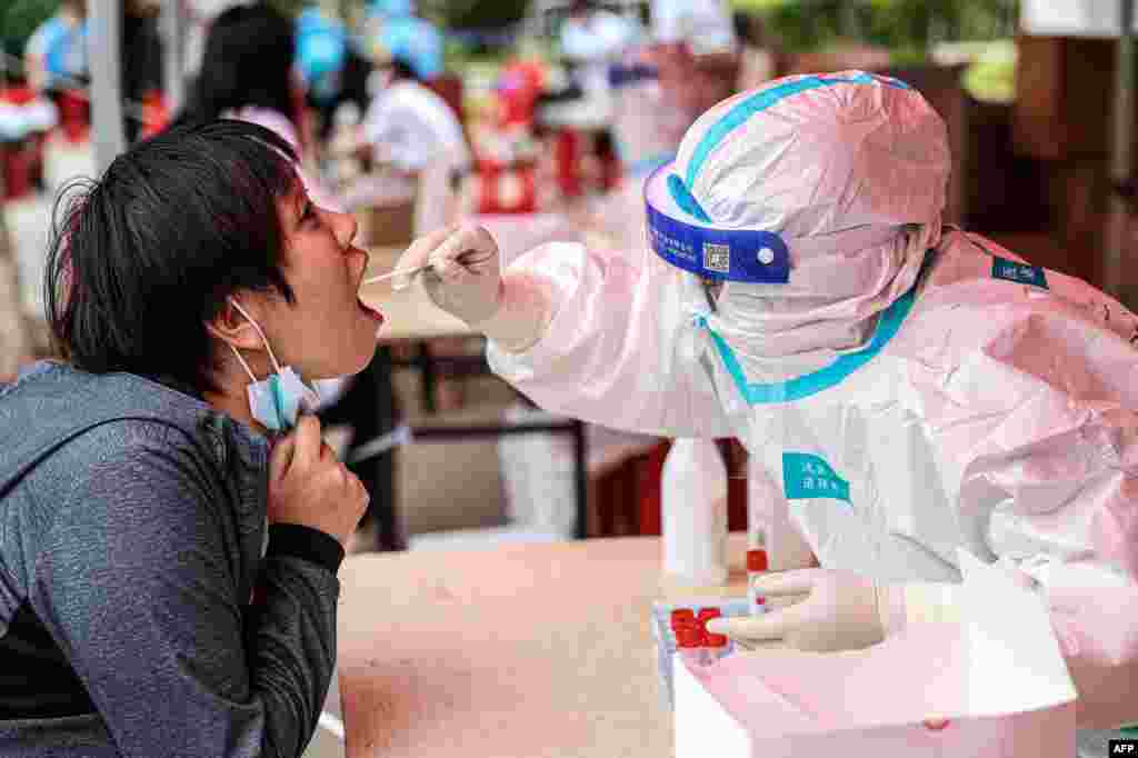 A health worker takes a swab sample from a resident to test for the COVID-19 coronavirus in Shenyang, in northeastern China&#39;s Liaoning province.