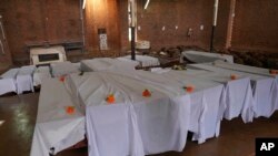 FILE—Coffins containing newly discovered remains of victims of the 1994 genocide arranged before a funeral ceremony inside a Catholic church, in Nyamata, Rwanda, April 5, 2024.