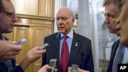 Senate Finance Committee Chairman Orrin Hatch speaks with reporters on Washington's Capitol Hill, Dec. 14, 2015, as lawmakers rush to wrap up their work and pass a funding bill to avert a government shutdown.