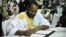 FILE - Sidi Brahim Ould Sidati, a member of the Arab Movement of Azawad, signs the peace accord on behalf of the Coordination of Azawad Movements in Bamako, Mali, June 20, 2015.