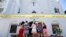 FILE - A group of women pray together at a makeshift memorial on the sidewalk in front of the Emanuel AME Church, in Charleston, S.C., June 18, 2015. Dylann Roof shot a killed nine people in a bible study at the church. 
