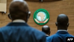 FILE — African leaders stand in front of the symbol of the African Union during the 39th ordinary session of the executive council of the African Union, in Addis Ababa, Ethiopia, on October 14, 2021.