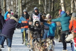 FILE - Defending Iditarod champion Joar Lefseth Ulsom of Norway greets fans on the trail during the ceremonial start of the Iditarod Trail Sled Dog Race, March 2, 2019, in Anchorage, Alaska.