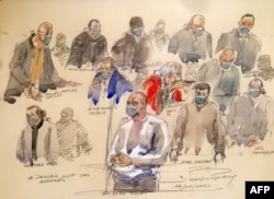 A courtroom sketch made on Dec. 14, 2020 shows Ali Riza Polat, center, speaking in front of other defendants at the Paris courthouse, Dec. 14, 2020.