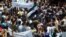 A handout image released by the Syrian opposition's Shaam News Network shows anti-regime demonstrators during a protest in Homs province, May 25 , 2012.